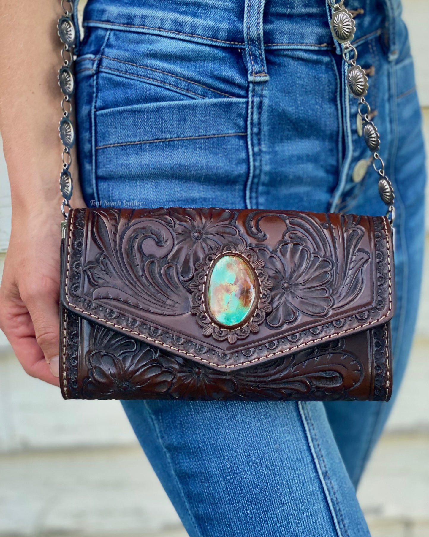 Small dark brown tooled leather cross body purse with tyrone turquoise and concho chain