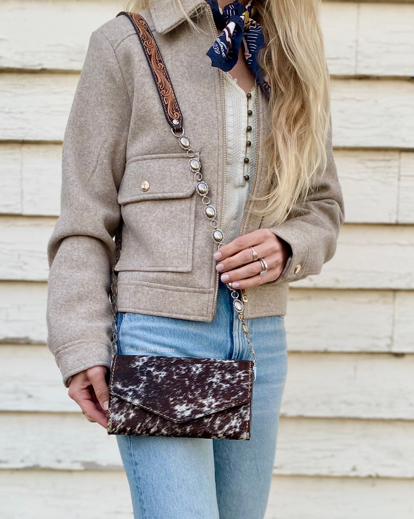 Small hair on hide cross body purse with tooled leather and concho chain