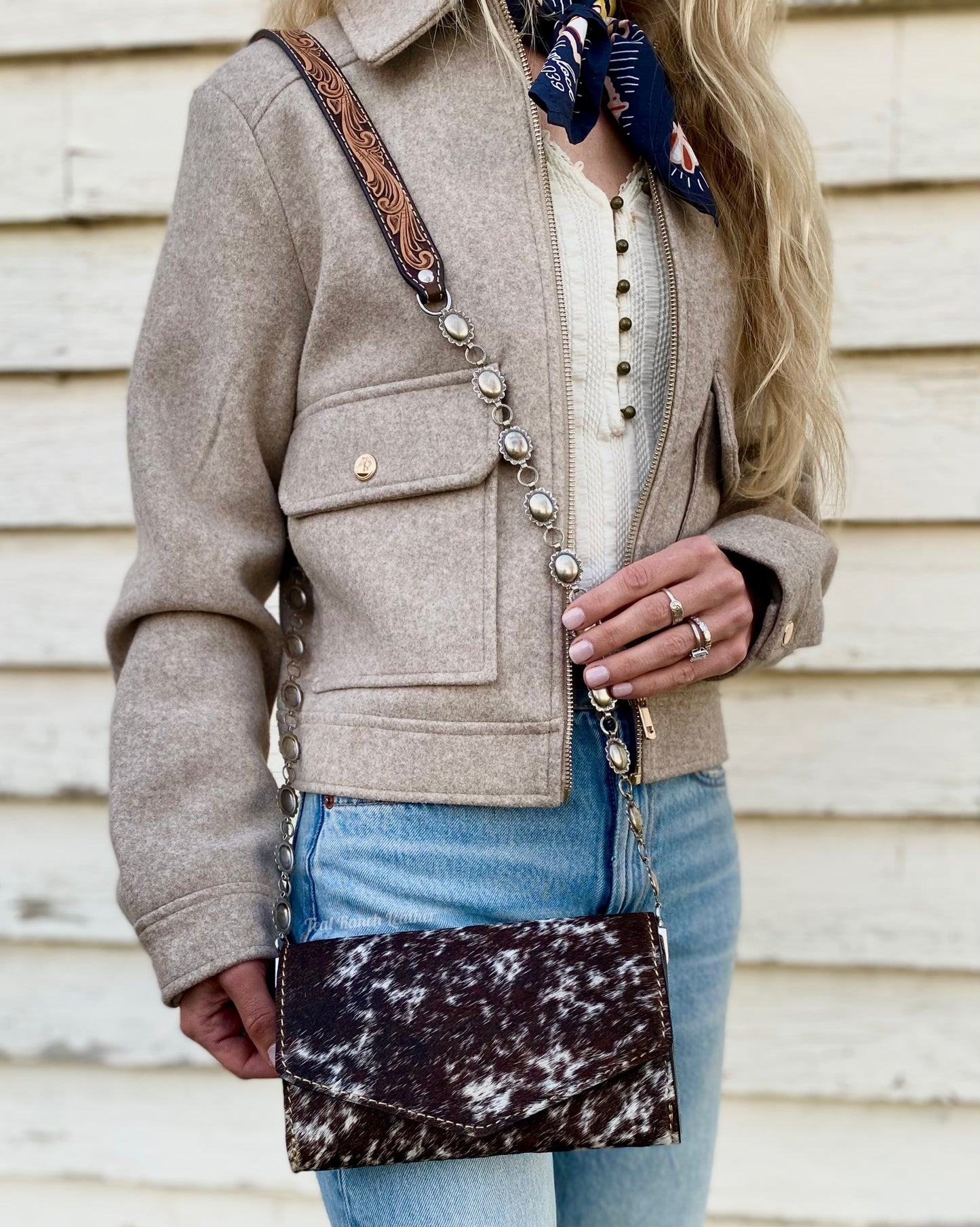 Small hair on hide cross body purse with tooled leather and concho chain