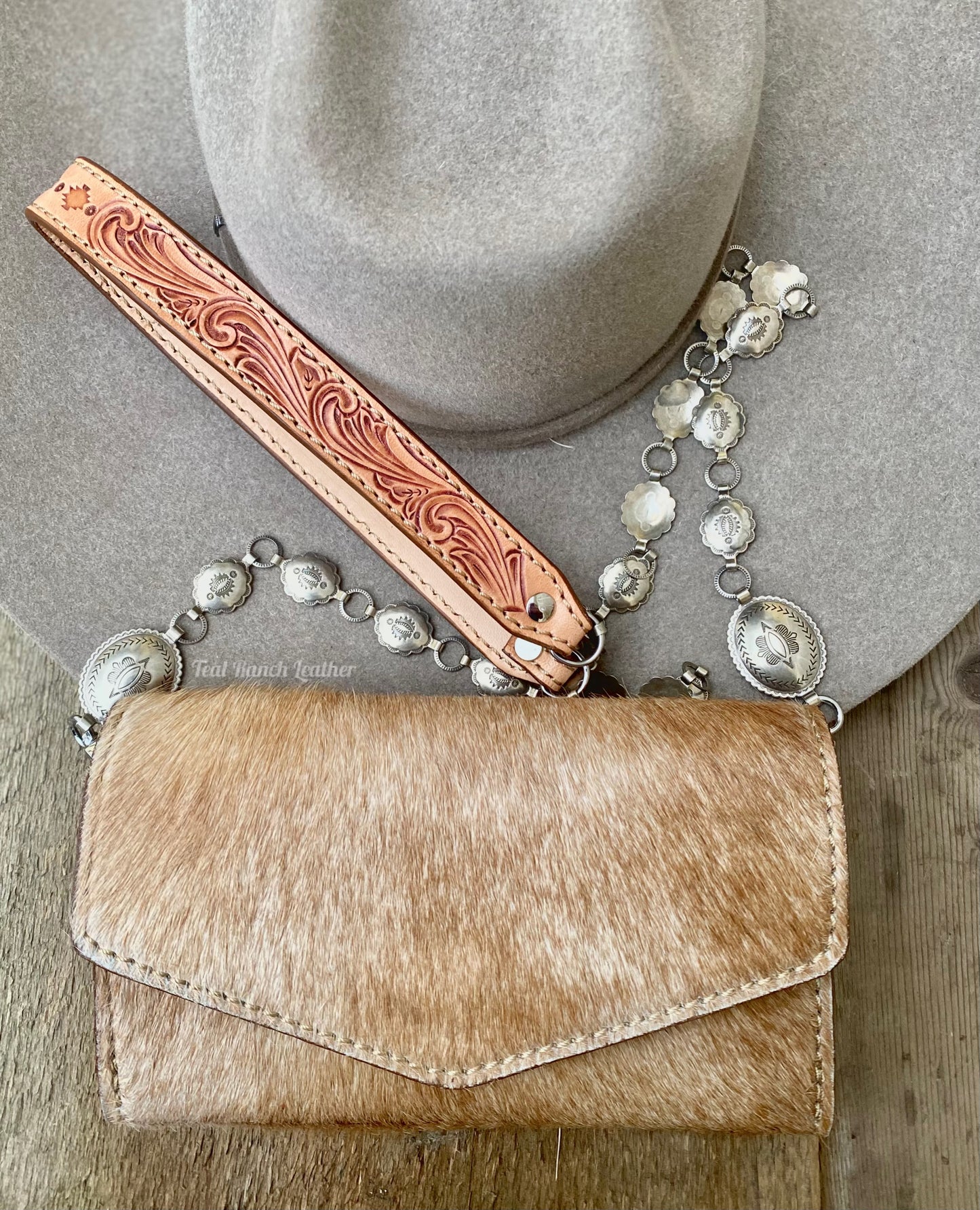 Small hair on hide cross body purse with tooled leather and concho chain- Light tan