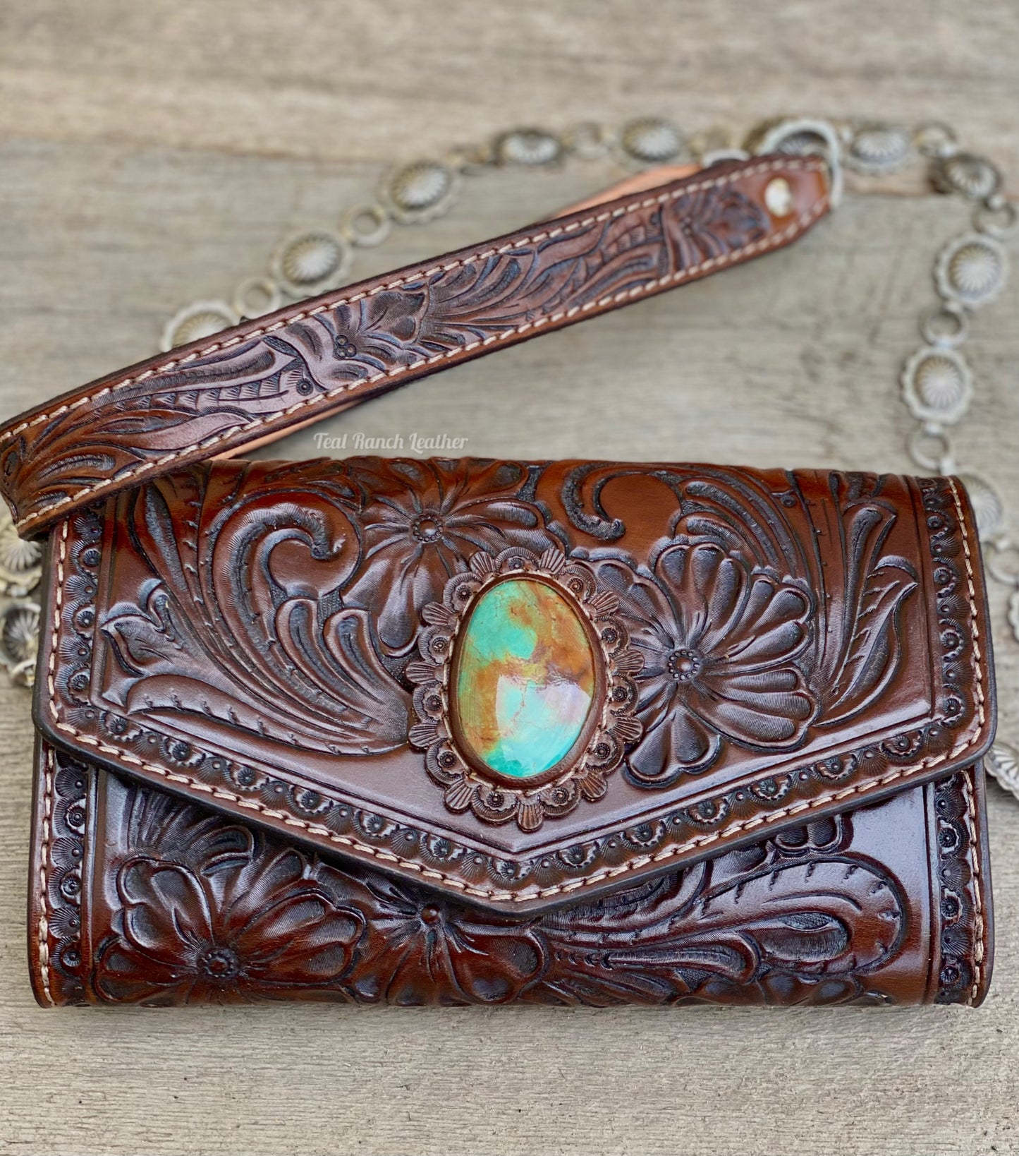 Small dark brown tooled leather cross body purse with tyrone turquoise and concho chain