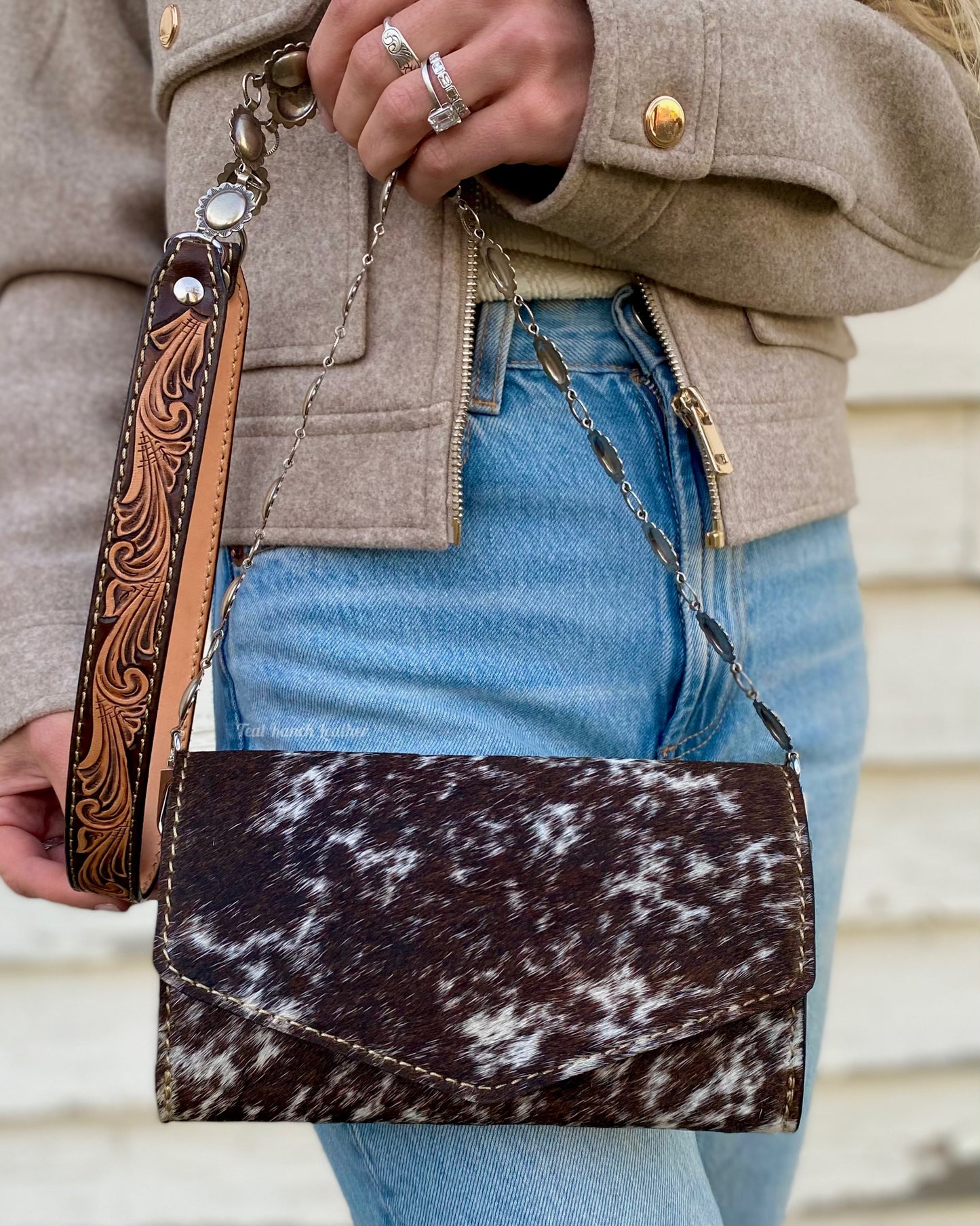 Small hair on hide cross body purse with tooled leather and concho chain