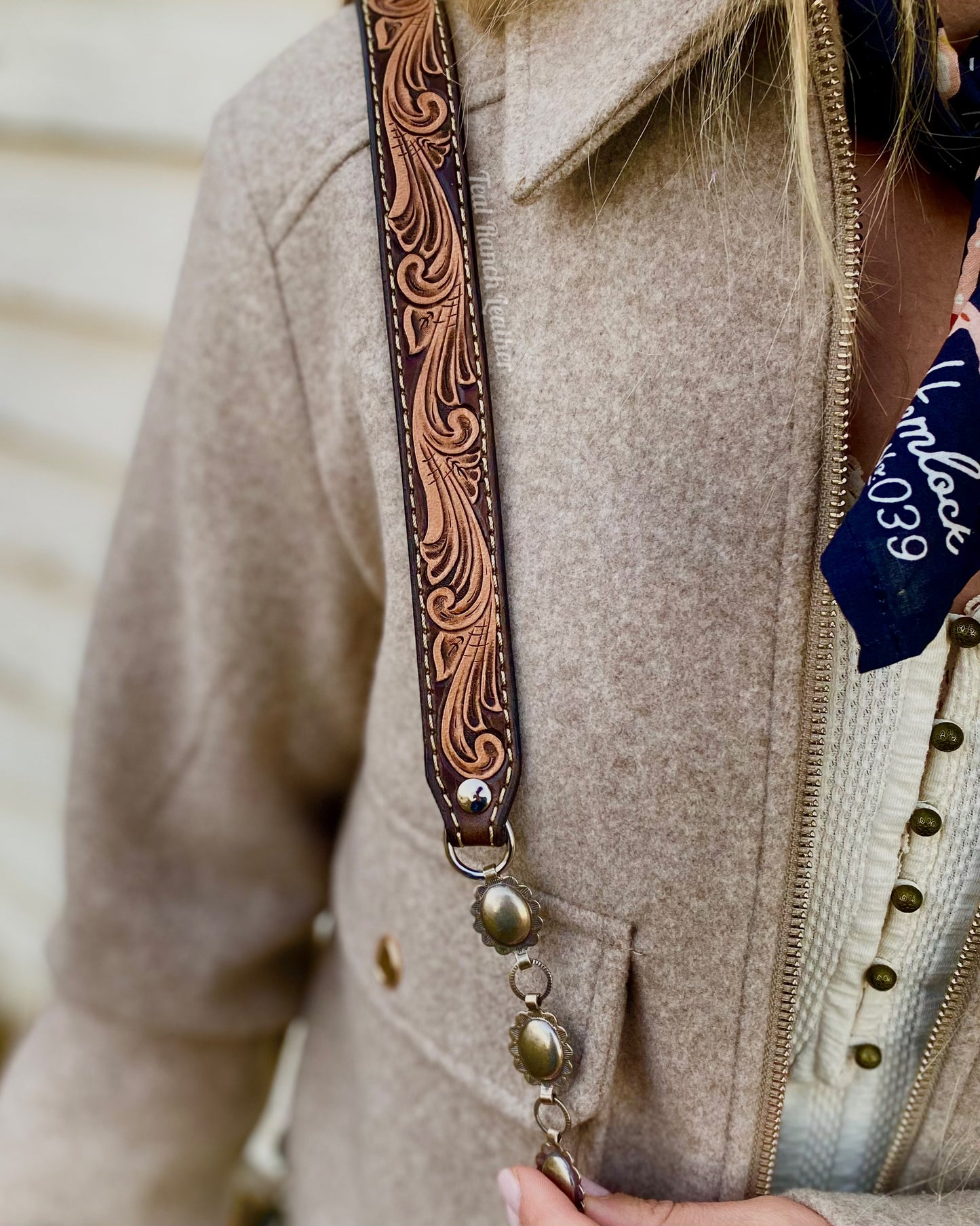 Small hair on hide cross body purse with tooled leather and concho chain