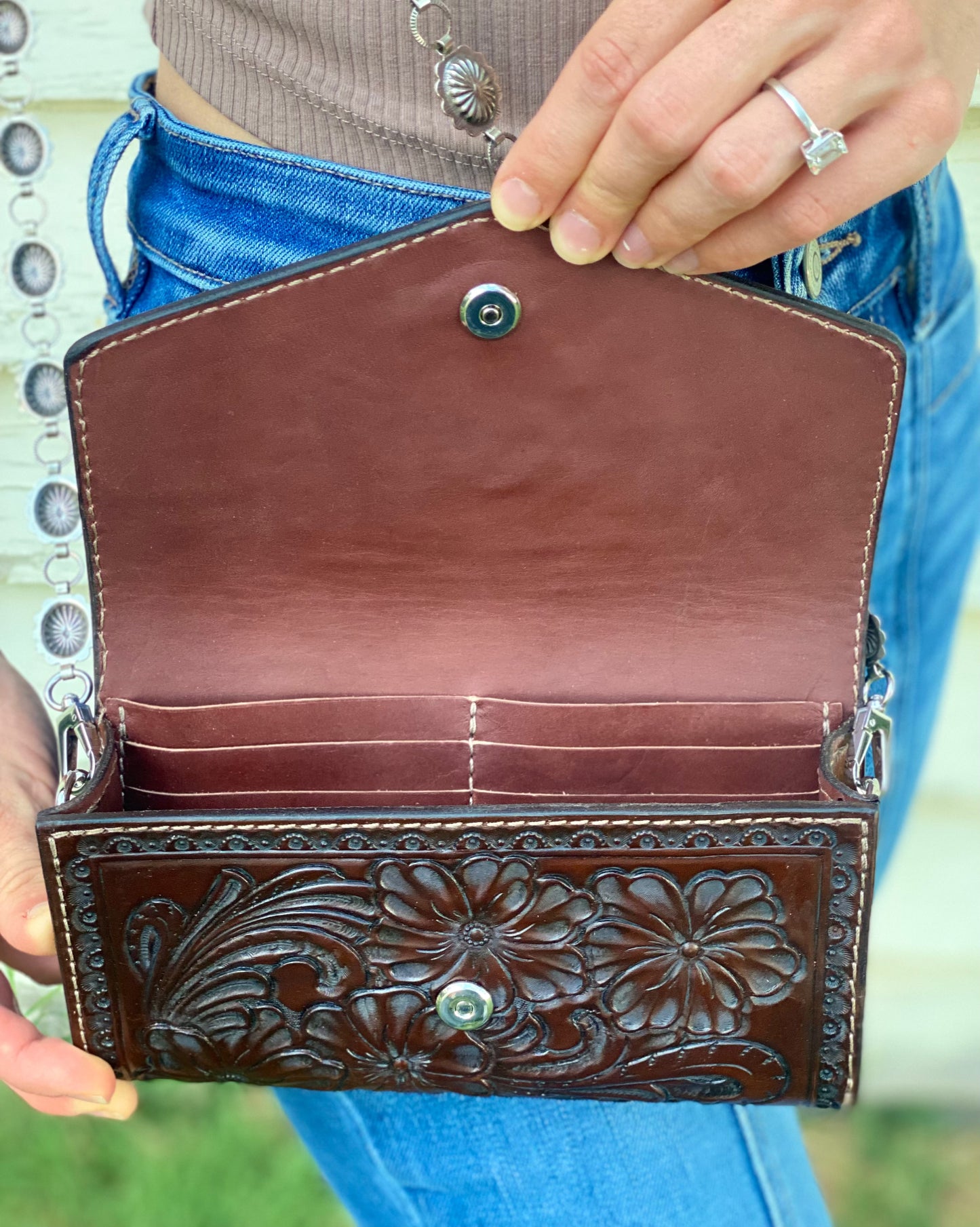 Small dark brown tooled leather cross body purse with tyrone turquoise and concho chain