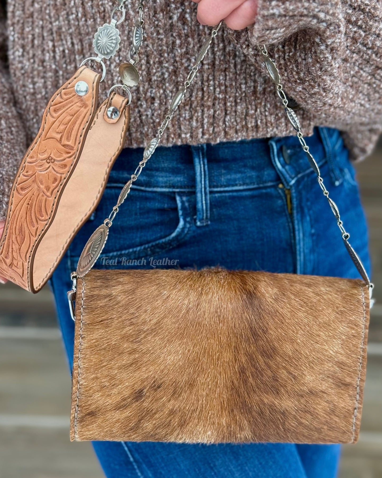 Small hair on hide cross body purse with tooled leather strap and concho chain