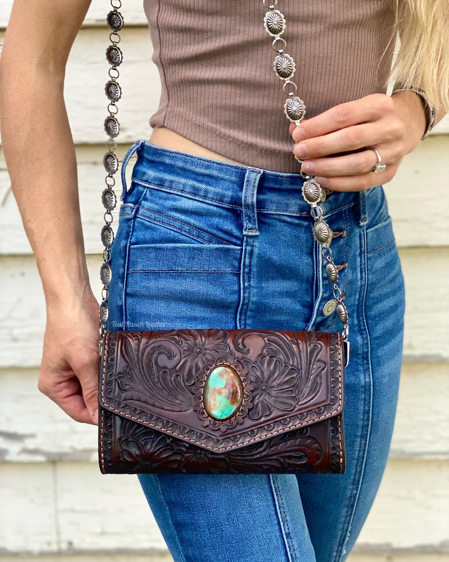 Small dark brown tooled leather cross body purse with tyrone turquoise and concho chain