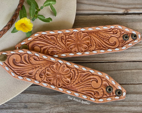 Tooled leather cuff with white buckstitch