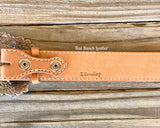 Tooled leather belt with dark background